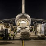 Air cargo aircraft loading freight at an international airport logistics hub